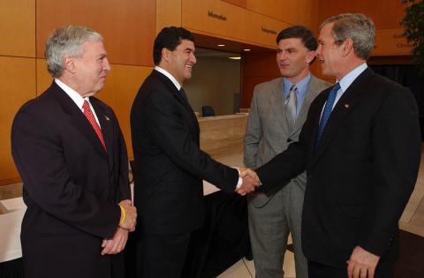 Zerhouni shaking President George W. Bush's hand in the Clinical Center atrium in 2005