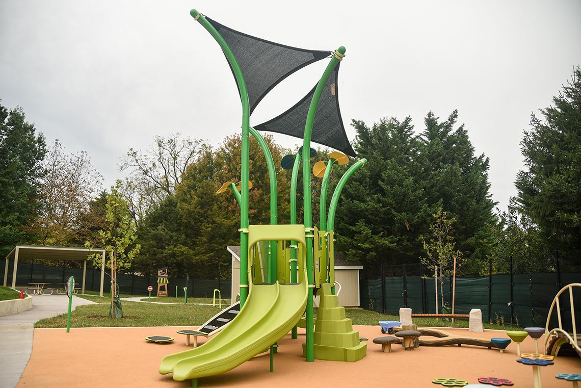 A view of the renovated playground. The equipment is lime green. 
