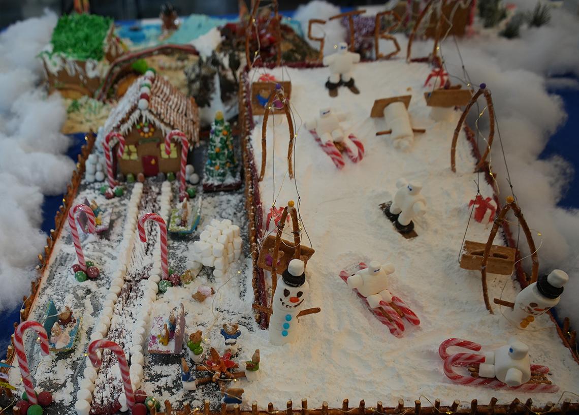 Little snowmen on candy cane sleds go down the hills.